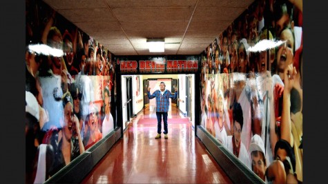 Senior Weston Berger poses in the hallway connecting to the field house, surrounded by images of cheer, something he strives to create at each of Centrals student events. 