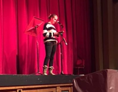 Elizabeth Storr, sophomore, recites poetry during the Poetry Slam. 