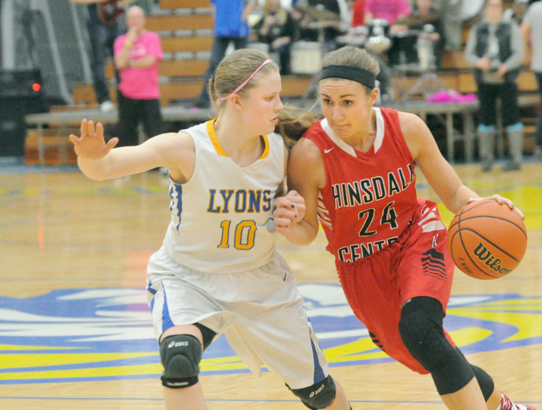 Varsity girls basketball player, Gabrielle Rush, senior, drives through the Lyons Township defense. 