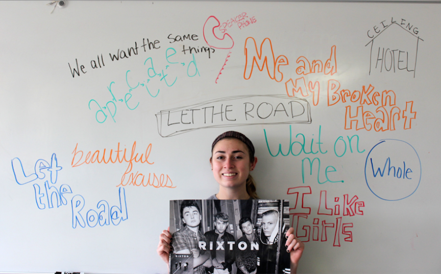 Julia Guglielmo, senior, poses under the song titles from Rixtons debut album, Let the Road. 