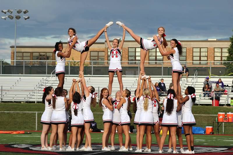 Central cheerleaders rally the crowd at a football game during the fall season. Lately, some students have wondered if cheerleaders can cheer at all sports throughout the year. 