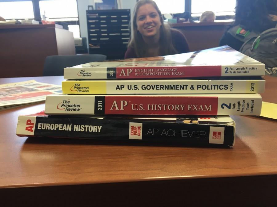 Junior Sophia Slone looks on at the AP textbooks; with registration happening now, most students are currently considering whether or not AP is for them. 