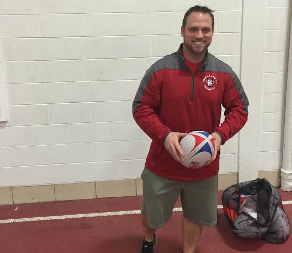 Rugby coach Nick Gebhart prepares the new rugby team for its practice. Rugby became a Central team recently and will begin competing against other schools in April. 