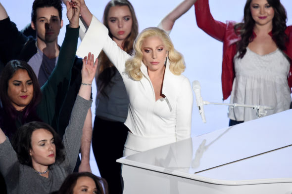 Lady Gaga standing with victims of sexual assault after a tearjerking performance.