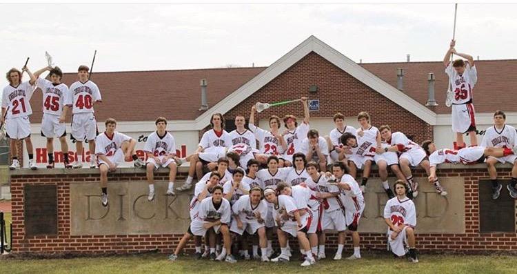 Boys varsity lacrosse team poses on Dickinson Field during their picture day. 