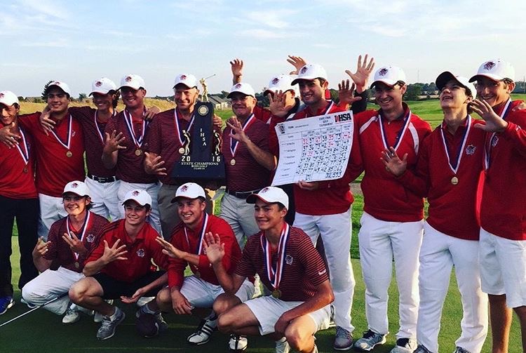 The team holds the scorecard and the trophy as they celebrate the win at State on Oct. 15. 