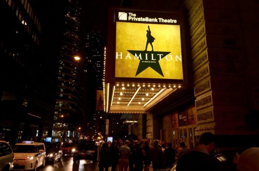The marquee at the PrivateBank Theatre glows to give Hamilton a prominent place amongst the other city lights in downtown Chicago.
