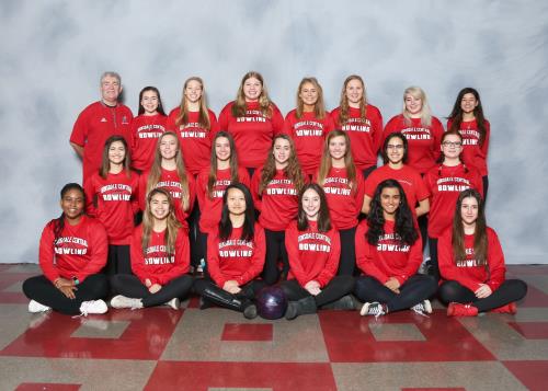 Girls bowling poses as a team in their spirit wear