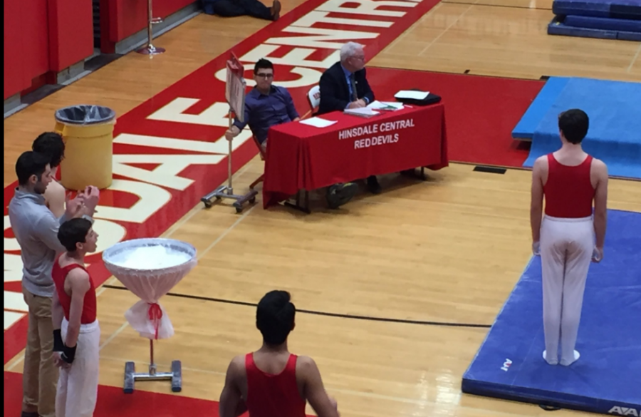 Hinsdale Central gymnasts performs in front of a few judges.
