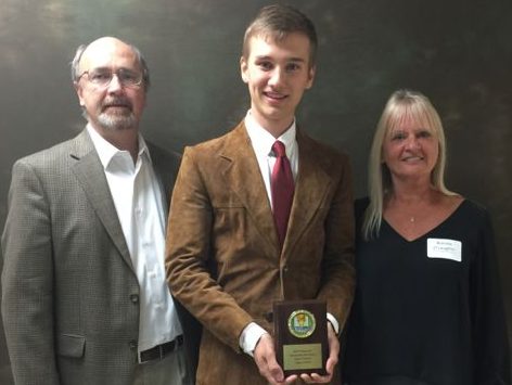 Last year’s Kelly Joy O’Laughlin Memorial Scholarship recipient, Jimmy Walker, poses with Kelly O’Laughlin’s parents. 