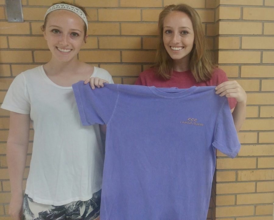 The sisters display their first t-shirt from the brand that features a sea-inspired logo. 