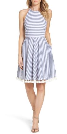 A striped fit and flare dress with a halter neck and side-seam pockets allows for girls to bring some small makeup items. 