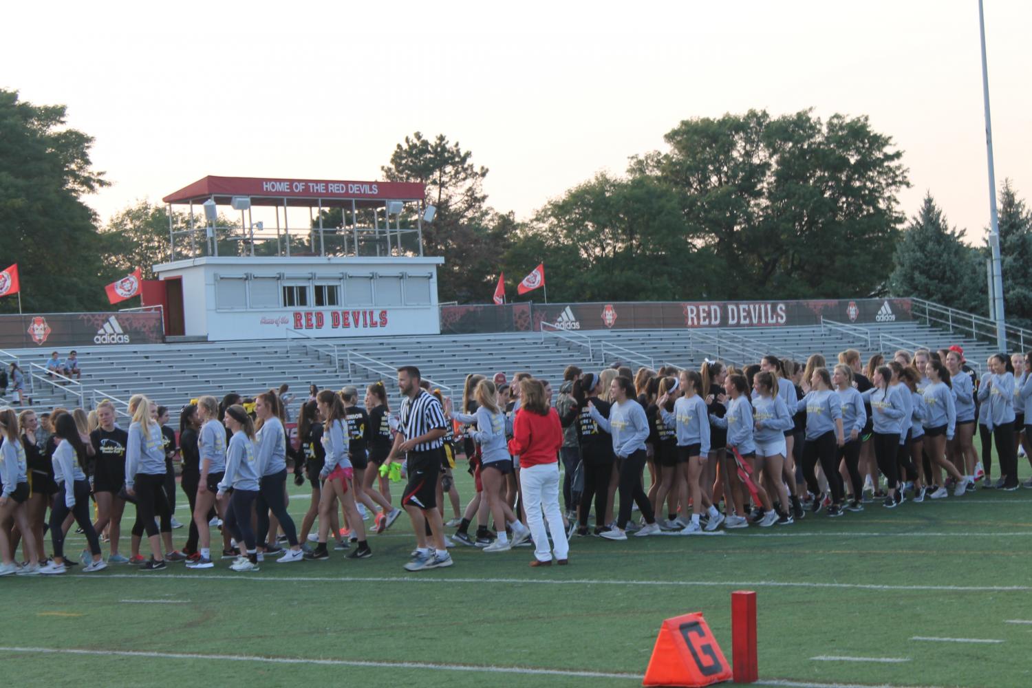 The juniors warmed up before the start of the annual powderpuff game against the seniors. The game marks the beginning of homecoming week. 