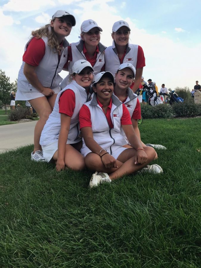 The girls team poses for a picture after a long day of golf.