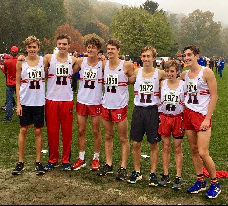Part of the boys varsity cross country state team poses after running the three-mile race for State.
