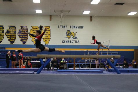 Sophomore Emma Baroni (left) performs her floor routine at the meet. 