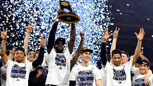 Villanova team members raise their third National Championship trophy in three years.