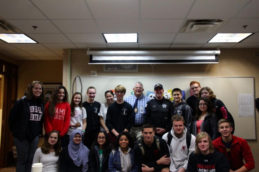 Members of the club took a picture with a visiting local police officer who came to speak to them as well as the sponsor, Officer Holecek. 