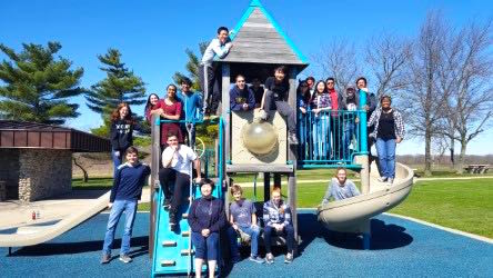 The Science Olympiad team poses in front of playground near the UIUC campus at the beginning of their weekend. 
