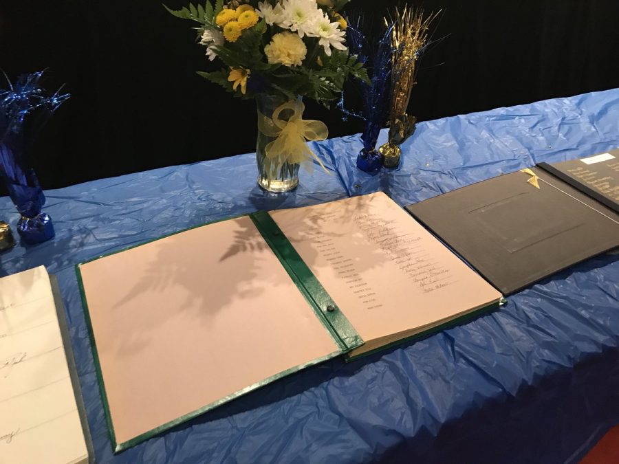 After being inducted into the National Honors Society on Thursday, April 26, inductees then carried out the tradition of signing their name in a book where all past RDN inductees have signed as well.