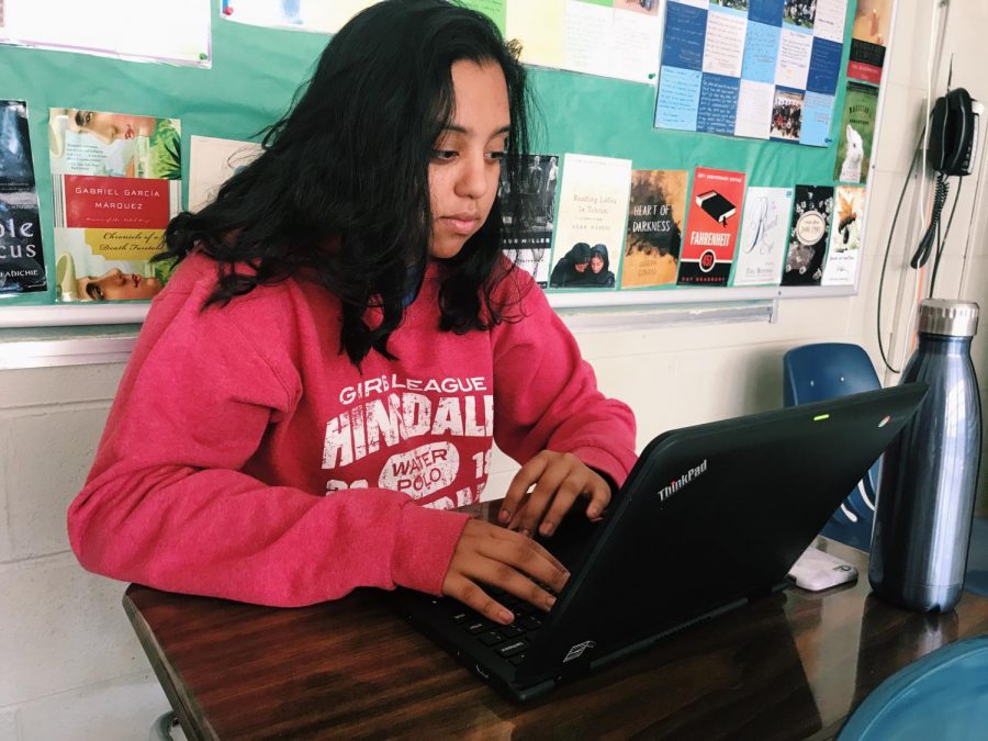 Junior, Aman Natt, works on the Chromebook in her AP Literature class to complete an in-class essay.