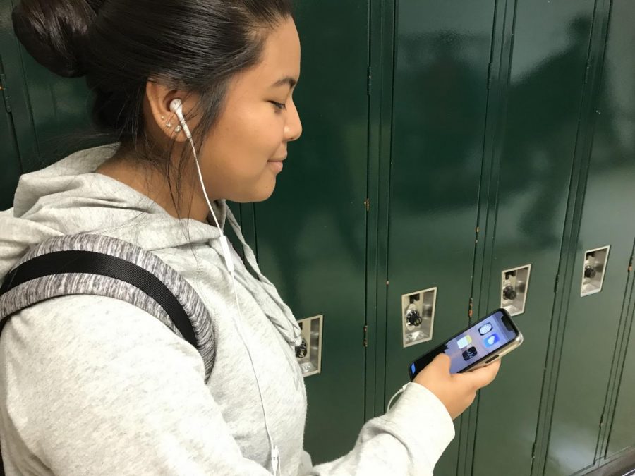 Kimberly Jaramillo, junior, blocking out the music with her headphones.