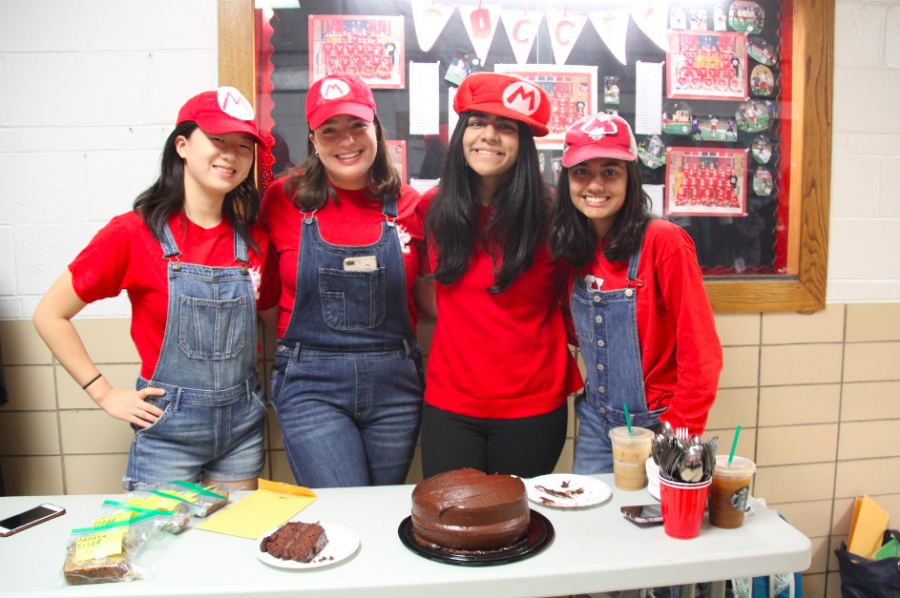 NHS members, Melissa Li, Ella Pope, Ameera Ilyas, and Shreya Sharma are depicted above dressed as Mario for the bake sale. 