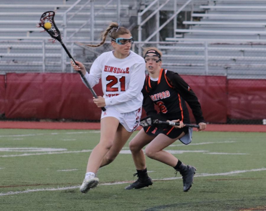 Sydney Collignon, senior midfielder, is about to charge up the middle and score a goal against the Rockford Rams. 