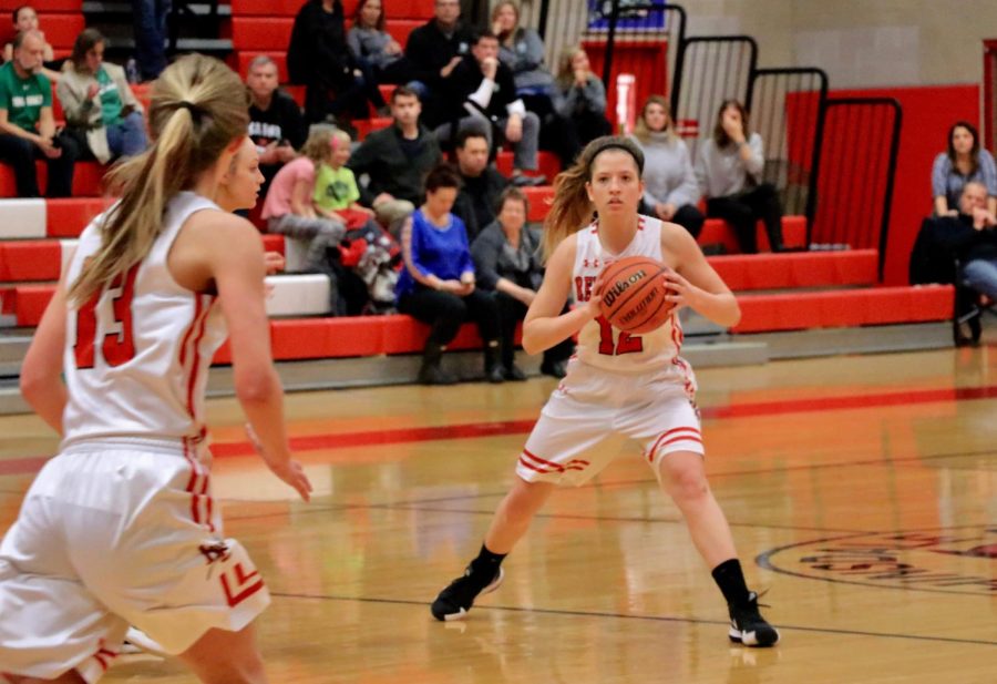 Madeline Bokich, senior, passes to her teammate Anna Howell, junior, during the game against York. 