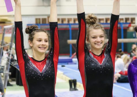 Annette Sommers, freshman, and Caroline Klobach, junior, stand next to each other, with both receiving all around athletes in the varsity West Suburban Conference meet at York Community High School on Jan. 26. 