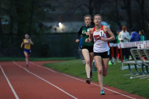 Mckenna Revord, junior, leads the 3200 meter run throughout the entire race, in front of former all state runners Katie Hohe of Glenbard West, and Sarah Barcelona of Lyons Township. 