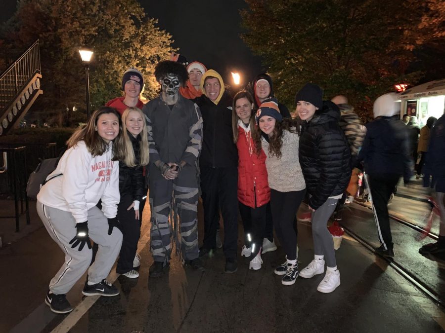 A group of juniors poses with one of the monsters from Fright Fest. These actors are scattered throughout the amusement park and scare any passerby. 