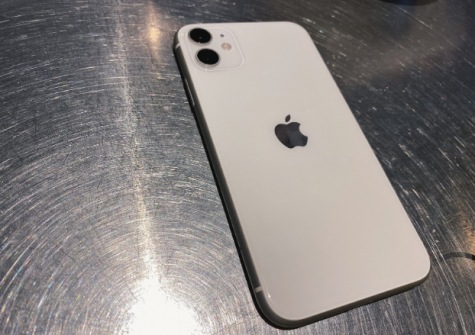 The iPhone 11 in white contains a glossy glass back screen as well as two separate camera lenses for different angles. 
