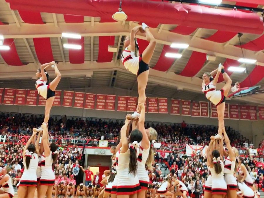 Varsity Cheerleaders stunt during their pep rally performance for Homecoming on Friday, Sept. 27.
