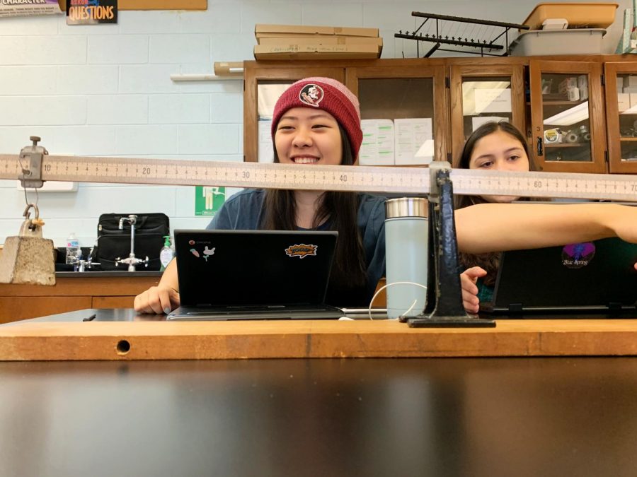 AP Physics students perform a lab, comparing the difference between a short-handed and long-handed lever.