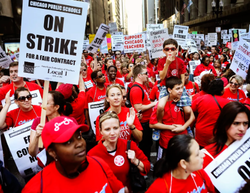 CPS teachers march down the streets of downtown Chicago to demand for better benefits and an extension of the social support network at schools. 