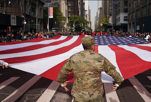 Veterans and active service members of the U.S. Armed Forces are cheered and honored by spectators at the New York City Veterans Day Parade. 