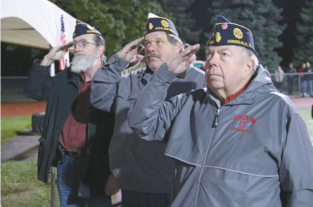 Veterans salute the flag as their service is commemorated during the annual Salute to Service football game in October. 