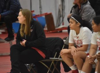 Coach Rogala sits court side during a sophomore basketball game. 