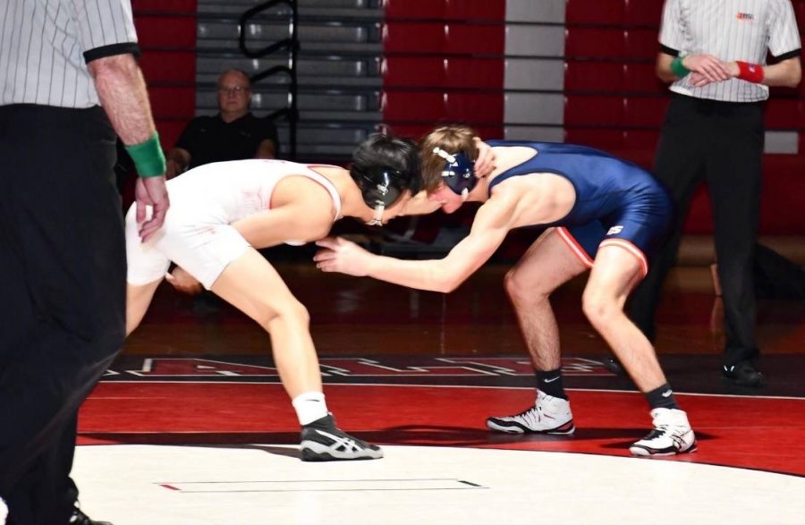 Tim+Song%2C+junior%2C+wrestles+opponent+at+the+IHSA+state+sectionals%2C+which+occurred+on+Feb.+14+an+15.+