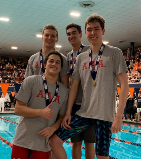 Ozgen, Cho, Cochlan, and Lahmann pose with their medals after they win first place in the 200-yard medley relay. 