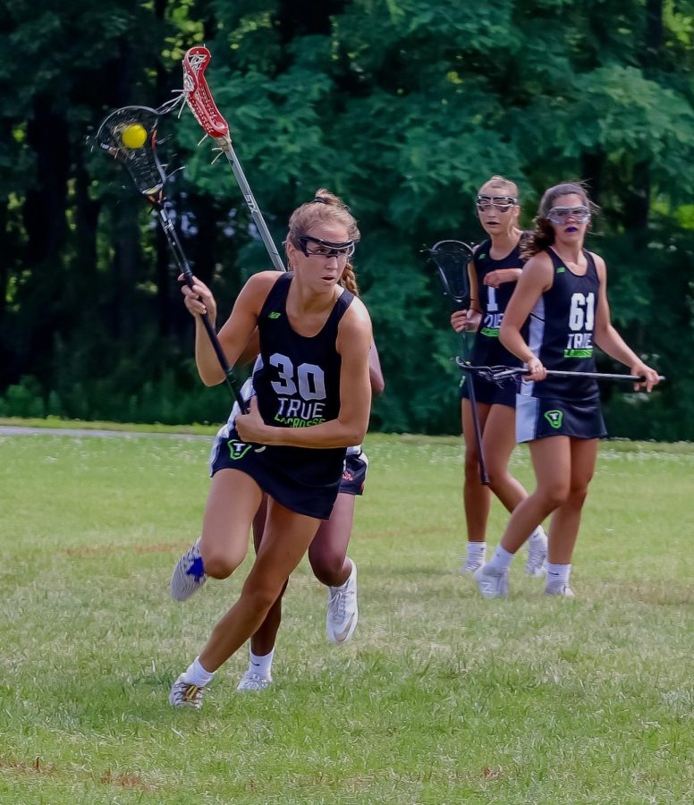 Sofija Buzelis speeds away from her teammates with ball in hand. Buzelis recently committed to playing lacrosse in college. 
