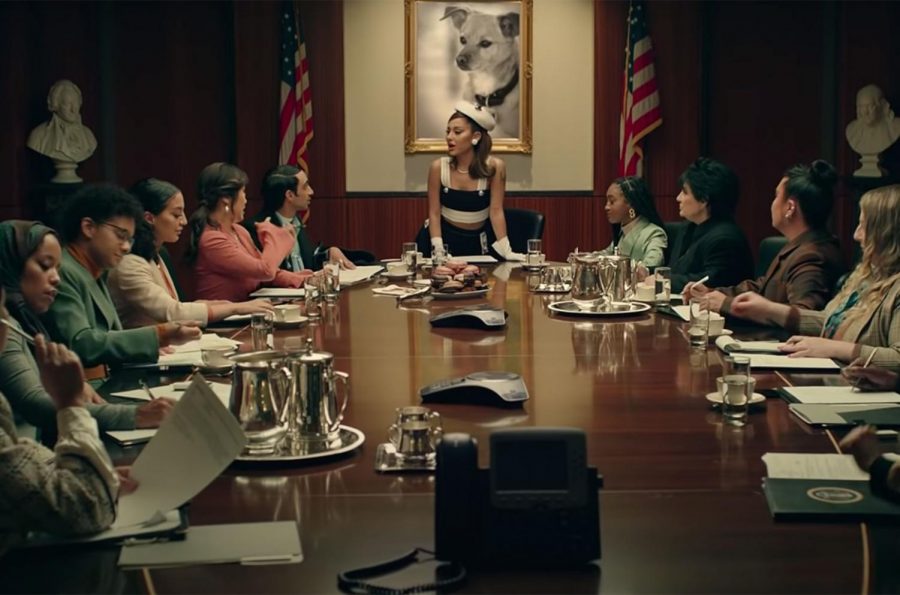 In the Positions music video, Grande can be seen in a presidential boardroom surrounded by women. She commands the attention of the room and shares her knowledge with the others.