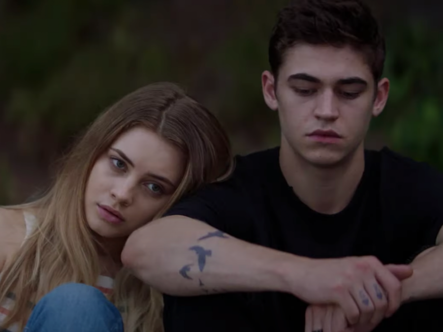 Hardin, played by Hero Fiennes-Tiffin, and Tessa, played by Josephine Langford, sitting together on a dock that in the movie was their special place. 