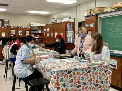 Art teacher Laura Milas mentors students in her painting course in September. 