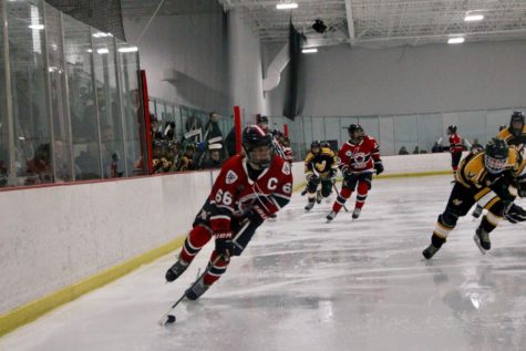 Zach Devine carries the puck into the Waubonsie zone. He would score two goals in the game.