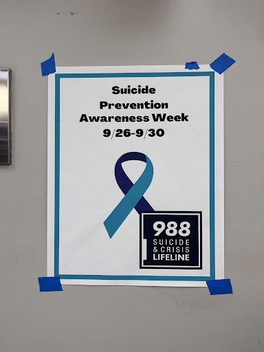 Pictured is a poster showing the 988 suicide and crisis lifeline posted in the school.