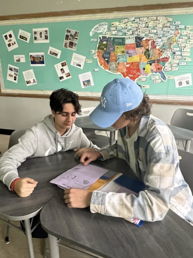 Students, Tim and Kevin, study for their math final, helping each other with the questions they dont understand. 