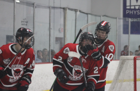 Seniors Charlie Riehle, Pete Cook and Colin Sullivan celebrate after one of Hinsdale Central’s seven goals against Sandburg. 