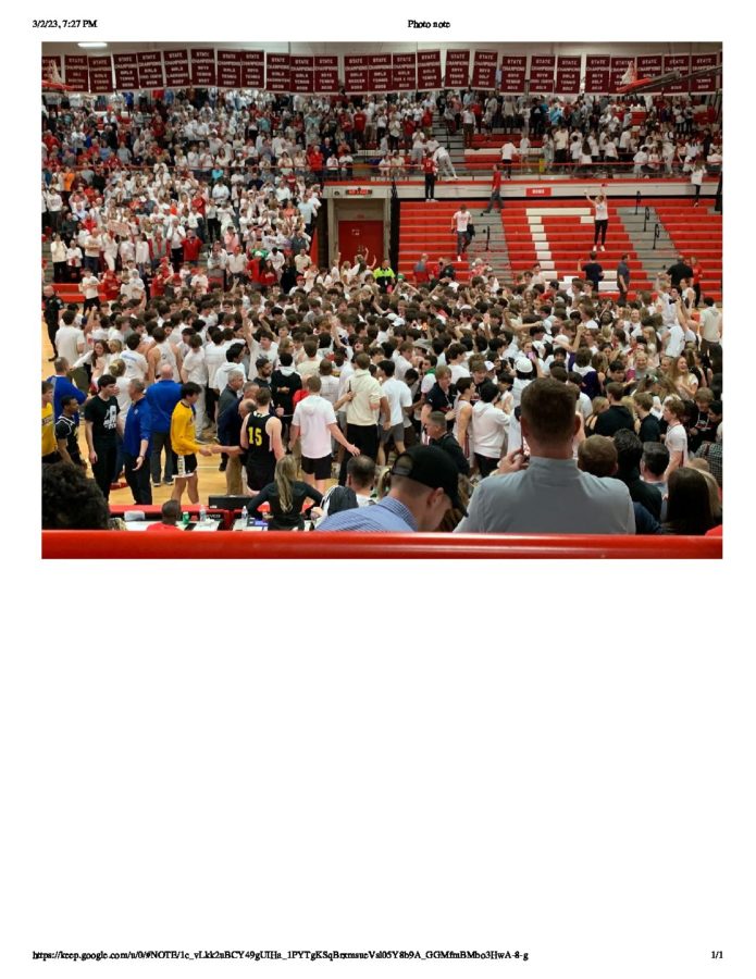 Students rush to the court as Hinsdale wins the game. (Alex Olguin)